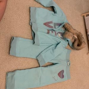 Sweat pants and jacket with faux fur lined hood.